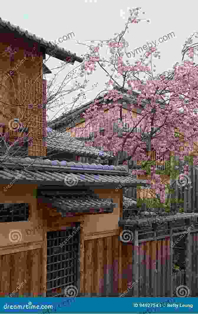 A Serene Countryside Landscape In Japan With Traditional Houses And Cherry Blossom Trees In Bloom. Japan (Countries Around The World)