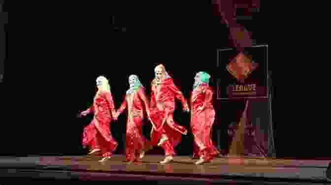 A Vibrant Depiction Of Traditional Iraqi Dance, Showcasing The Expressive Movements And Colorful Costumes Of The Performers. Guests Of The Sheik: An Ethnography Of An Iraqi Village